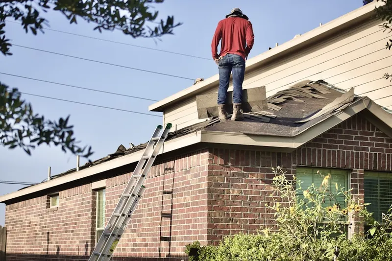 Professional roofer working on a residential roof in Davie